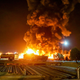 A fierce blaze broke out at the refinery in southern Tehran after a liquefied gas line leaked and exploded. Flames light up the night sky.